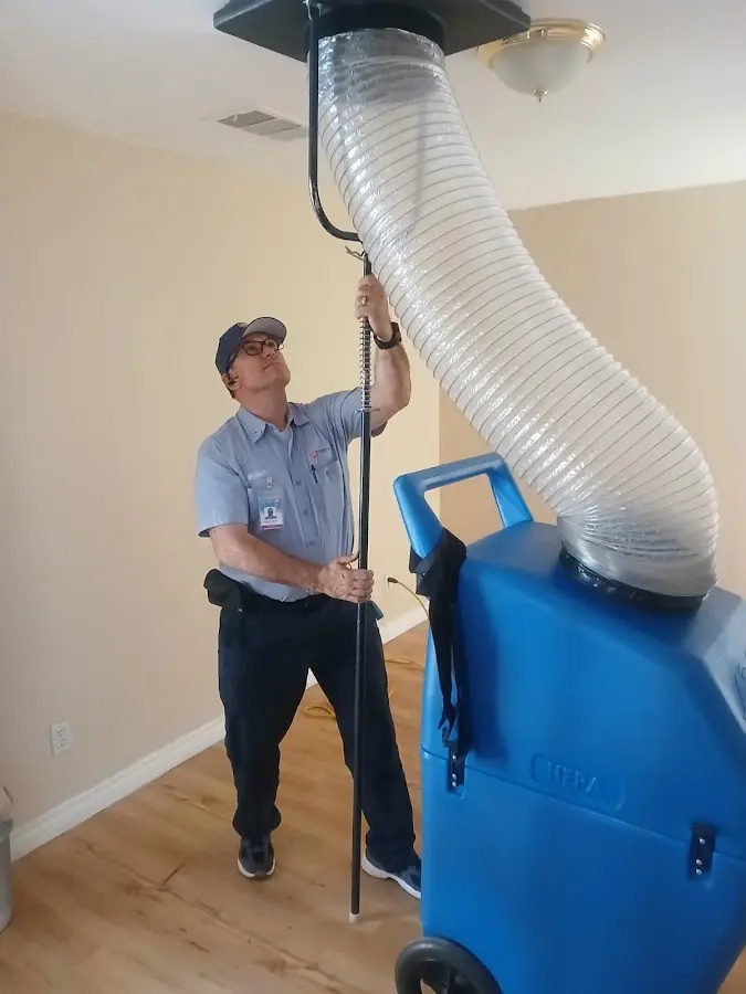 Furnace Tune-Up technician using HEPA equipment in Ballston